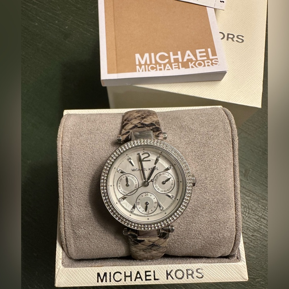 Michael Kors timepiece on snakeskin band.
